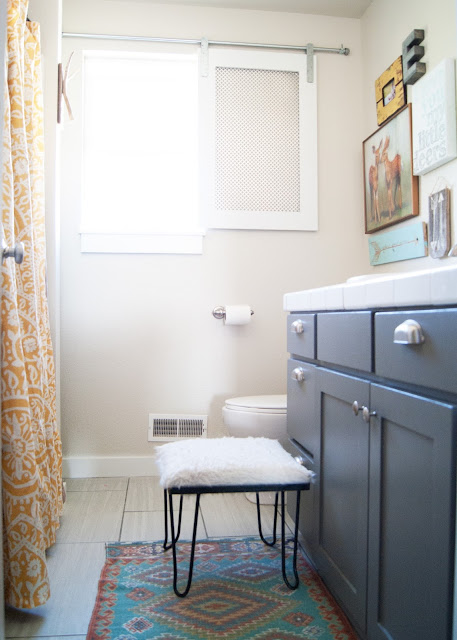 Bathroom Makeover - before & after - World Market rug / mat and vintage hairpin leg stool