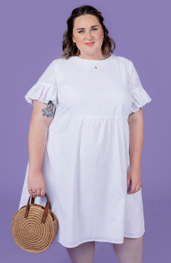 Bethany wearing a white broderie anglaise Indigo dress