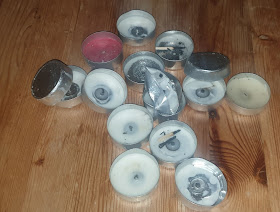 A scattered arrangement of burnt-down and crushed tea lights