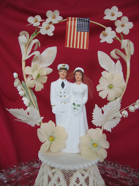 Here's a 1950 military wedding cake topper with a 48stars flag