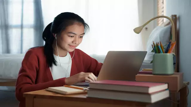 A student using a computer to access e-learning resources