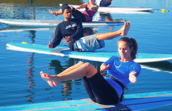 Students participating in SUP Yoga
