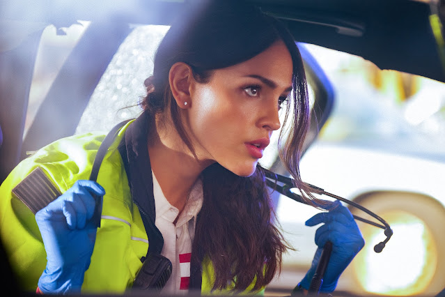 a woman in an EMT uniform