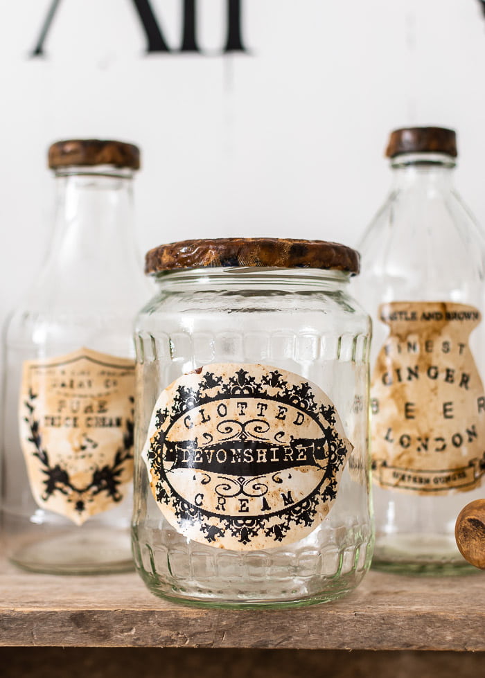 glass jars with vintage advertising labels, rusty lids