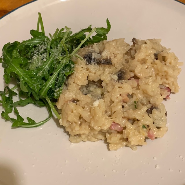 Bacon and mushroom risotto, with a side of dressed rocket