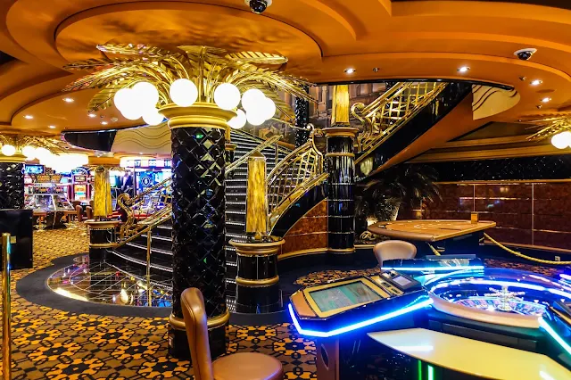 Shiny black pillars with gold and gambling tables in a Casino on MSC Preziosa