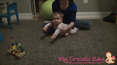 Baby with torticollis lunging towards a toy