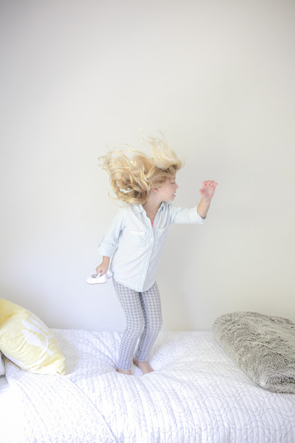 Amy West's daughter jumping on bed