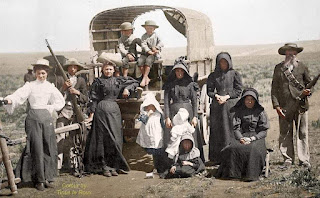 Boer family traveling by covered wagon circa 1900