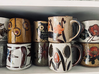 A cupboard of vintage mugs