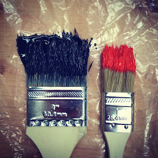 two used paint brushes on clingflim