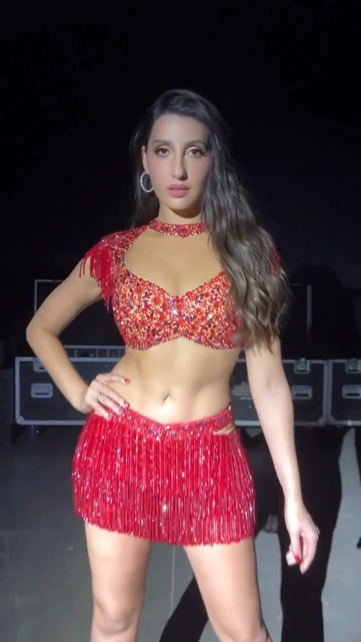 nora fatehi red outfit navel legs tour