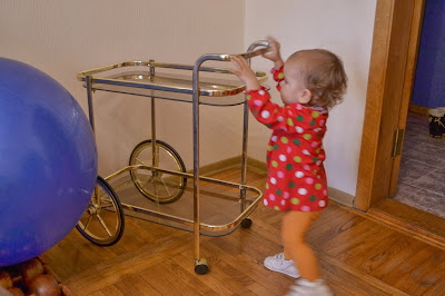 a small girl is moving the table in the living-room