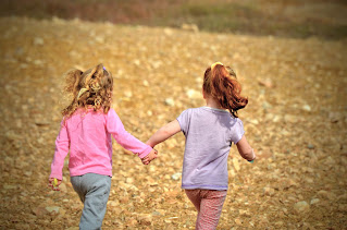 two little girls holding hands