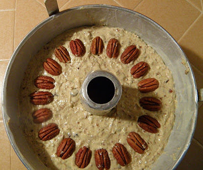 Overhead view of batter decorated with pecans