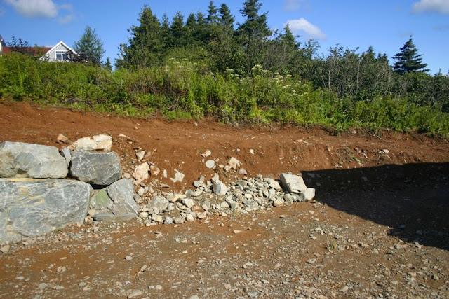 back hoe landscaping preparations for rock gardens