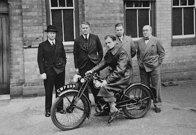 Creators gather with Royal Baby motorcycle.