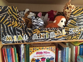 Stuffed toys in a zoo themed box