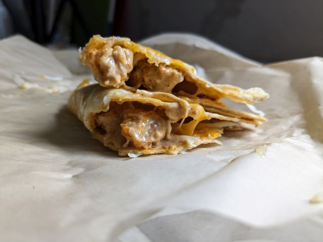 The cross section of a Taco Bell Cantina Chicken Crispy Taco.