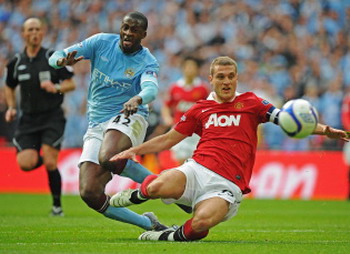 Toure with Vidic, Manchester City - Manchester United