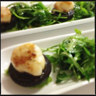 Scallops with black pudding, pea purée & rocket salad