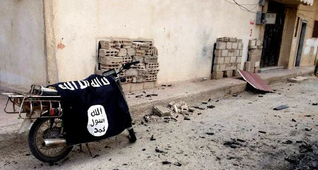 Image Attribute: A flag belonging to the Islamic State fighters is seen on a motorbike after forces loyal to Syria's President Bashar al-Assad  recaptured the historic city of Palmyra, in Homs Governorate in this handout picture provided by SANA on March 27, 2016. REUTERS/SANA/Handout via Reuters