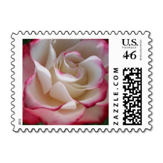 US postage stamp with a white rose with red tips