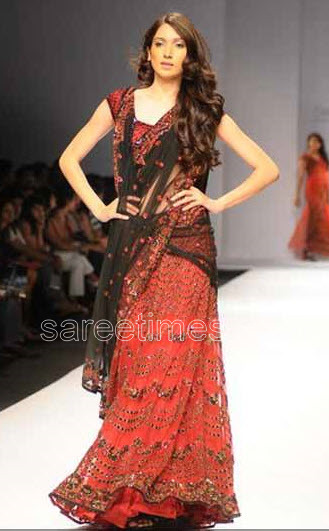 Model displaying beautifully embellished designer half saree with enticing