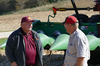 Extension educator Brad Carlson talks with farmer