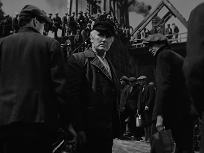 Gwilym (Donald Crisp) looks sadly back at the men shut out of the mine - including two of his sons.