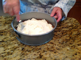 spreading sour cream in spring form pan