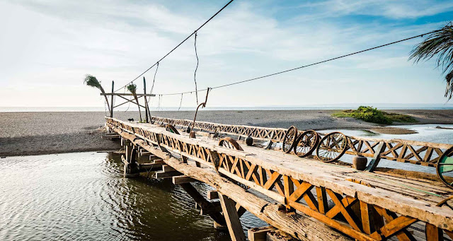 Kayu Putih Beach - Beach With a Backdrop of a Wooden Bridge that Extends Over the Lagoon