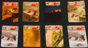 Eight catastrophe cards. Each contains art with a one or two icons in the top section. Art includes: a house collapsing as a crevasse opens in the ground, a stone altar spattered with blood, a village on fire during the night, a flood washing through a village, a mother sheep and her lamb in the snow, a tornado, a locust on a plant stalk, and a repeat of the mother sheep and lamb.