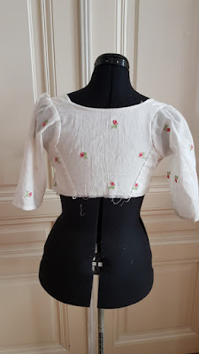 back bodice of a regency dress on a black dress doll