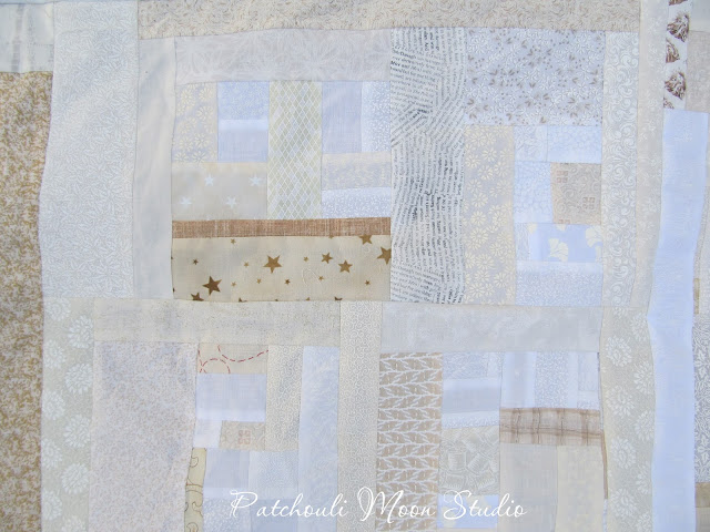 closeup of Scrappy pieced background fabric for table runner in white and off white fabrics