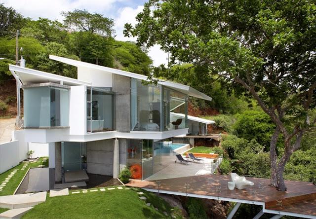 Photo of an amazing modern home as seen from the elevated place nearby