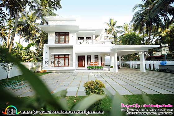 Flat roof construction finished house with green plans surrounding