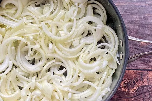 Onions frying in a large pan.