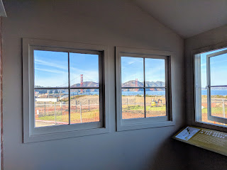 The Golden Gate Bridge is visible through windows at the back of the visitor center.