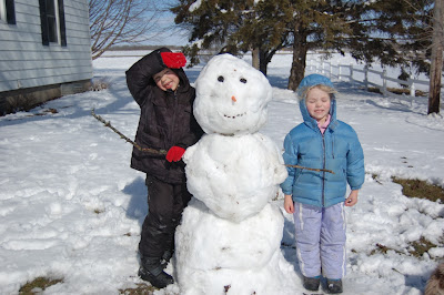 farm kids with April snowman