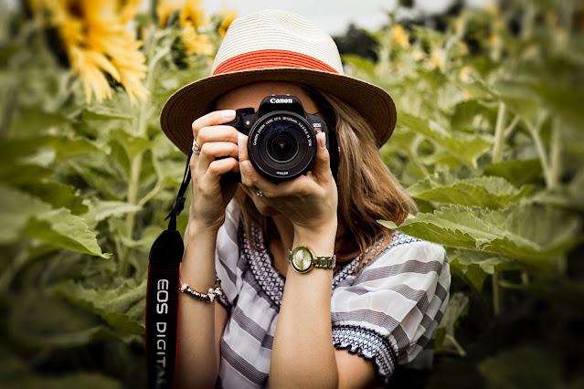 https://www.pexels.com/photo/selective-focus-photography-of-woman-holding-dslr-camera-1264210/
