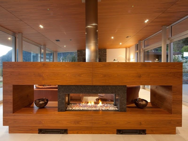 Wooden fireplace in the glass house 