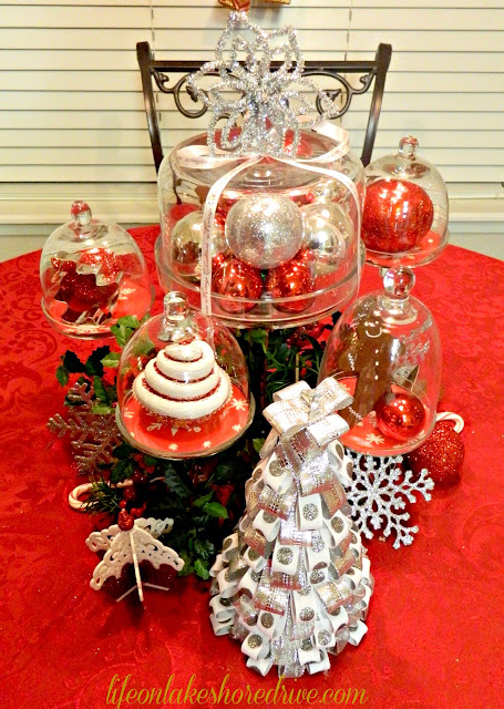 alt="Red and silver Christmas tablescape, cloches, mini cupcake stands"