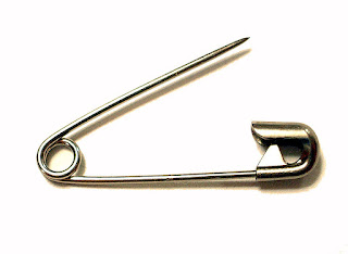 Pin is a variation of a needle equipped with a simple spring mechanism and hook