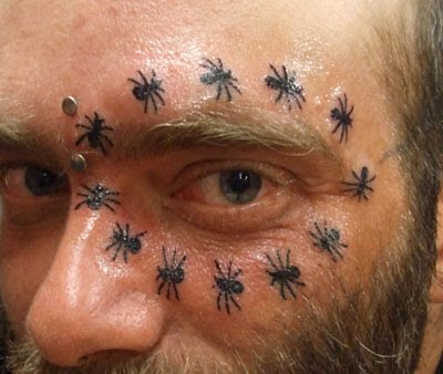 Ant around eye facial tattoo