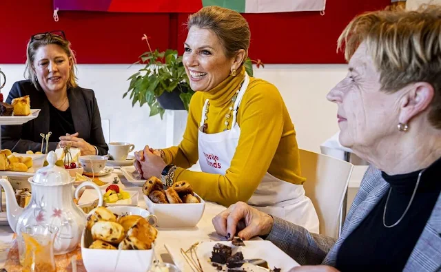 Queen Maxima wore an embroidered coat by Oscar de la Renta, and yellow sweater and yellow pants by Max Mara