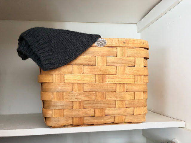 Peterboro Basket used to store winter hats and gloves in a closet shelf