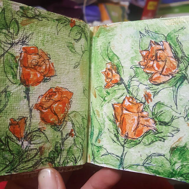 rosas pintadas con acuarela y tinta en una libreta (artjournal)