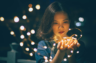 Girl holding bright lights