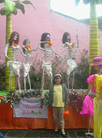 Miriam posing next to a Carnaval de la Muerte float